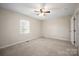 Cozy bedroom featuring neutral colored carpet, a ceiling fan and lots of natural light at 1330 5Th Ne St, Hickory, NC 28601