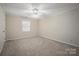 Neutral bedroom with carpet, white ceiling fan, one window, and natural light at 1330 5Th Ne St, Hickory, NC 28601