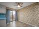 Cozy dining area with neutral floors, floral wallpaper, and sliding glass doors leading to the patio at 1330 5Th Ne St, Hickory, NC 28601