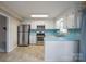 Bright kitchen featuring white cabinets, stainless steel appliances, blue countertops, and natural light at 1330 5Th Ne St, Hickory, NC 28601