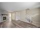 Spacious living room featuring wood-look floors, a fireplace, and staircase to the upper level at 1330 5Th Ne St, Hickory, NC 28601