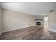 Inviting living room featuring wood-look floors, a white brick fireplace, and an open floor plan at 1330 5Th Ne St, Hickory, NC 28601