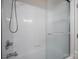 White tiled shower with modern fixtures and glass door at 1330 5Th Ne St, Hickory, NC 28601