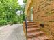 Backyard brick patio with brick stairs, landscaping, and privacy in a wooded setting at 13617 Lake Bluff Dr, Matthews, NC 28105