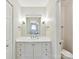 Bright bathroom features modern vanity, brushed nickel fixtures, and a toilet in a separate room at 13617 Lake Bluff Dr, Matthews, NC 28105