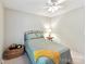 Comfortable bedroom with a ceiling fan, natural light, and room for a basket and side table at 13617 Lake Bluff Dr, Matthews, NC 28105
