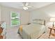 Cozy bedroom with large window, ceiling fan, and a hardwood dresser at 13617 Lake Bluff Dr, Matthews, NC 28105