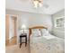 Bright bedroom featuring natural light, side table, and light-colored carpeting at 13617 Lake Bluff Dr, Matthews, NC 28105