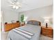 Bright bedroom with a ceiling fan, dresser, and natural light streaming through the windows at 13617 Lake Bluff Dr, Matthews, NC 28105