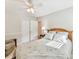 Cozy bedroom with ceiling fan, wood accents, and closet, perfect for relaxation at 13617 Lake Bluff Dr, Matthews, NC 28105