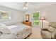 Comfortable bedroom with a recliner, dresser, and natural light at 13617 Lake Bluff Dr, Matthews, NC 28105