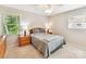 This bedroom features carpet flooring, natural light, and a neutral color palette at 13617 Lake Bluff Dr, Matthews, NC 28105