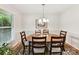 Cozy dining room with hardwood floors, a round table, and natural light, perfect for intimate gatherings at 13617 Lake Bluff Dr, Matthews, NC 28105