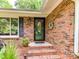 Inviting brick porch with decorative plants, a wreath, and a stylish front door creates a welcoming entry at 13617 Lake Bluff Dr, Matthews, NC 28105