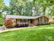 Beautiful brick home with a well-maintained lawn and mature landscaping, creating a welcoming entrance at 13617 Lake Bluff Dr, Matthews, NC 28105