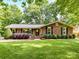Charming brick home with manicured lawn and lush landscaping, offering great curb appeal at 13617 Lake Bluff Dr, Matthews, NC 28105