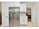 Stylish kitchen with stainless fridge, white cabinets, and natural light at 13617 Lake Bluff Dr, Matthews, NC 28105