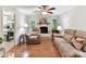 Cozy living room with white-painted brick fireplace and hardwood floors at 13617 Lake Bluff Dr, Matthews, NC 28105