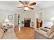 Bright living room with ceiling fan and hardwood floors at 13617 Lake Bluff Dr, Matthews, NC 28105
