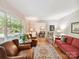 Bright living room featuring hardwood floors, neutral walls, and ample seating, perfect for relaxation and entertaining at 13617 Lake Bluff Dr, Matthews, NC 28105