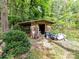 Backyard shed with overgrown landscaping offering storage space at 13617 Lake Bluff Dr, Matthews, NC 28105