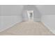 An attic room with beige carpet and one window at 15400 Groveland St, Huntersville, NC 28078