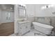Modern bathroom featuring a soaking tub, marble floors, and modern fixtures at 15400 Groveland St, Huntersville, NC 28078