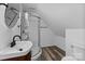 A modern bathroom featuring a shower and vanity with wood-look floors at 15400 Groveland St, Huntersville, NC 28078