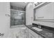 Gray-tiled bathroom featuring a glass-enclosed shower, marble floors, and a vanity at 15400 Groveland St, Huntersville, NC 28078