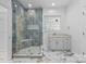 Beautiful bathroom featuring a tiled shower and a vanity with great natural light at 15400 Groveland St, Huntersville, NC 28078