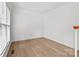 Bright empty bedroom featuring hardwood floors, a window with natural light, and neutral walls at 15400 Groveland St, Huntersville, NC 28078