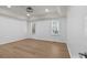 Spacious bedroom with tray ceiling, large windows, and hardwood floors at 15400 Groveland St, Huntersville, NC 28078