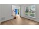 Bright entryway featuring hardwood floors, a staircase with wood banister, and natural light from a window at 15400 Groveland St, Huntersville, NC 28078