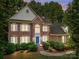 Beautiful brick home with a blue front door, manicured landscaping, and updated windows and shutters at 15400 Groveland St, Huntersville, NC 28078