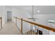 Hallway overlooking the downstairs living area with a fireplace at 15400 Groveland St, Huntersville, NC 28078