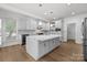 Spacious kitchen featuring a large center island, stainless appliances, and hardwood floors at 15400 Groveland St, Huntersville, NC 28078