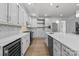Modern white kitchen featuring stainless steel appliances and large center island at 15400 Groveland St, Huntersville, NC 28078