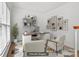 Bright staged office featuring a modern desk, stylish decor, and a comfortable seating area at 15400 Groveland St, Huntersville, NC 28078