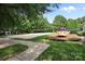 A community volleyball court and playground surrounded by lush green space, creating a recreational park at 15400 Groveland St, Huntersville, NC 28078