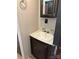 Bathroom sink with cabinet, white countertops and framed mirror at 155 Indian Harbor Trl # E243, Mount Gilead, NC 27306