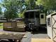 RV with outdoor seating and shed in wooded lot covered with gravel at 155 Indian Harbor Trl # E243, Mount Gilead, NC 27306