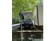 Golf cart near outbuilding with satellite dish and antenna at 155 Indian Harbor Trl # E243, Mount Gilead, NC 27306