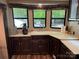 Modern kitchen with dark wood cabinets, corner sink, and stainless steel appliances at 155 Indian Harbor Trl # E243, Mount Gilead, NC 27306