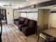 Living area with dark brown reclining chairs and sofa, flowing into the dining area at 155 Indian Harbor Trl # E243, Mount Gilead, NC 27306