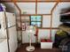 Outbuilding with shelving holding various items including a fan and tools at 155 Indian Harbor Trl # E243, Mount Gilead, NC 27306