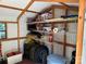 Organized shed interior with shelving, storage containers, and stacked tires at 155 Indian Harbor Trl # E243, Mount Gilead, NC 27306