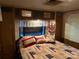 Cozy bedroom features built-in storage above the bed and a lace-trimmed window at 160/162 Arrowood Trl # F28/F29, Mount Gilead, NC 27306