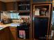 Efficient kitchen with wooden cabinetry, modern microwave, and black appliances at 160/162 Arrowood Trl # F28/F29, Mount Gilead, NC 27306