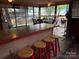 Outdoor covered seating area with tile topped bar, red stools, and view of exterior at 160/162 Arrowood Trl # F28/F29, Mount Gilead, NC 27306