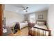 Bedroom featuring hardwood floors, neutral walls, two beds, a ceiling fan, and a built-in desk area at 1695 Arden Dr, Lincolnton, NC 28092